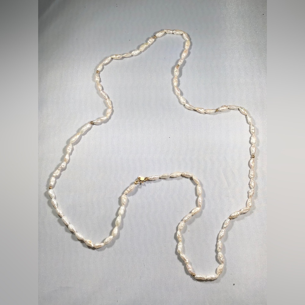 14 K  Gold and White Rice Pearl necklace.